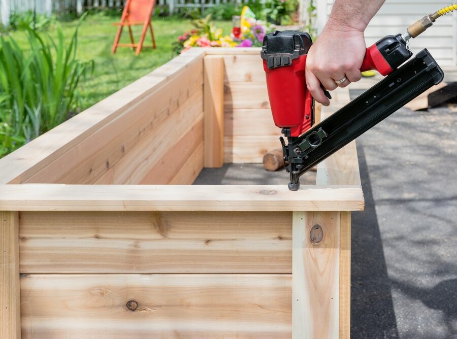 Closeup,Of,A,Man,Using,A,Pneumatic,Nail,Gun,To