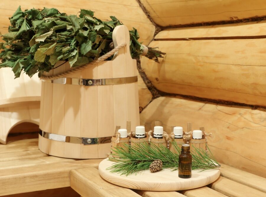 Bottle,With,Healing,Essential,Oil,For,Sauna,Near,Green,Pine