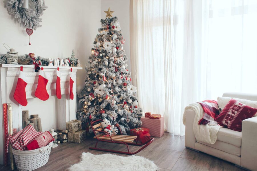 Beautiful holdiay decorated room with Christmas tree with presents under it