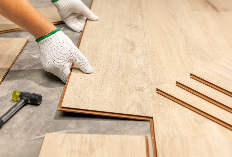 Worker,Installing,Interlocking,Laminate,Floor,,Home,Renovation.