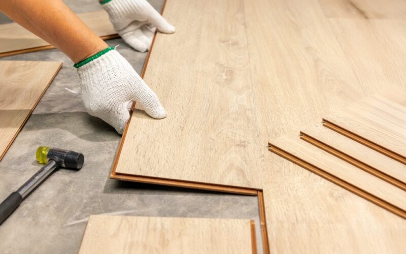 Worker,Installing,Interlocking,Laminate,Floor,,Home,Renovation.